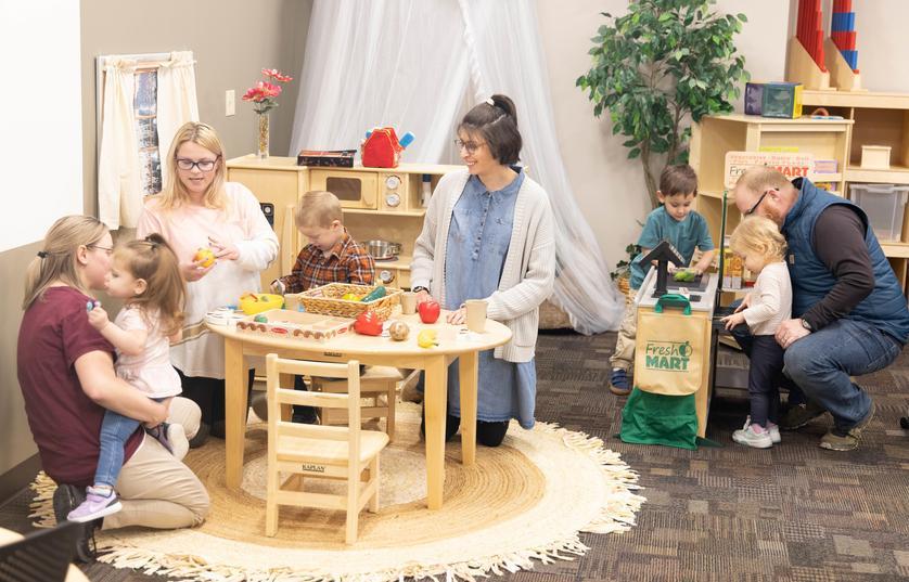 Teachers and children playing in Parent Child Center